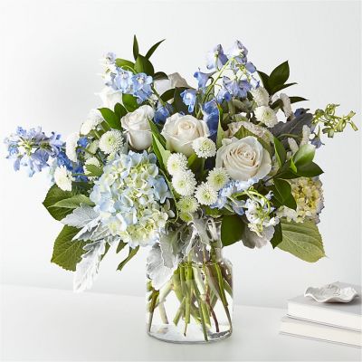 Let this uplifting arrangement be reminders of the clear skies ahead. Capturing the feeling of hope that a new day brings, this bouquet is composed of voluminous hydrangea blooms and vibrant belladonna delphinium to refresh their mood.