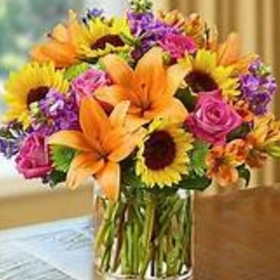 Vibrant colors, fragrant stock, sunny sunflowers, rich hot pink roses round out this stunning bouquet