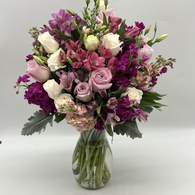 This beautiful bouquet features some gorgeous blooms that will brighten anyone's day with wonderful shades of purple!