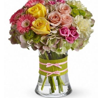 This arrangement would be perfect for any girl with an eye for style. It's a must-have for fashionistas everywhere. Gorgeous green hydrangea, yellow and light pink roses, pink spray roses, mini gerberas, light yellow carnations, and green button spray chrysanthemums are delivered in a pretty gathering vase. Not just any vase of course; this one's accessorized with a chartreuse taffeta ribbon and pink raffia. Approximately 10" W x 11" H