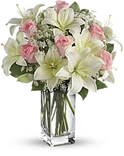 <div id="mark-3" class="m-pdp-tabs-marketing-description">Stunning in its simplicity, this innocent harmony of light pink roses and snow white lilies are a heartfelt way to send your very best. The classic, clear rectangular glass vase keeps the focus on the heavenly beauty of the blooms.</div>
<div id="desc-3">
<ul>
<li>Light pink roses and white asiatic lilies form a fragrant bouquet with delicate touches of Queen Anne's lace and rich green salal.</li>
</ul>
</div>