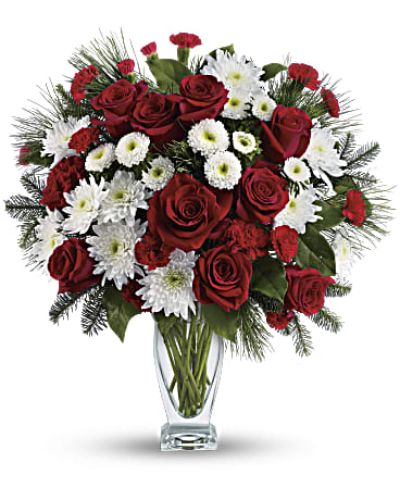 No mistletoe required! Simply send this romantic bouquet of snow whites and rich reds arranged in our sculpted glass vase, and you’re guaranteed a spot on her “nice” list.
This heartwarming bouquet includes red roses, red carnations, red miniature carnations, white matsumoto asters, white cushion chrysanthemums, noble fir, white pine and lemon leaf.