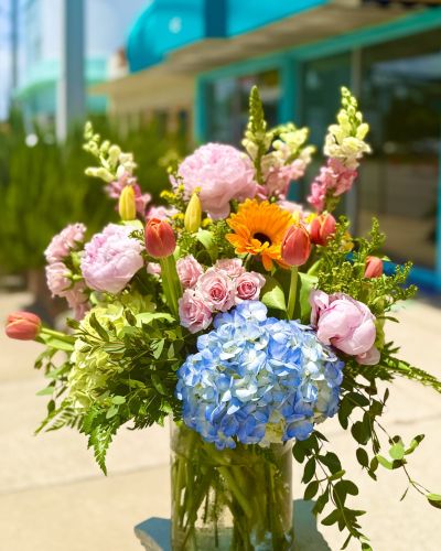 <p>Hydrangeas, Peonies, spray roses and more fill this lush cylinder bursting with color sure to be anyones Dream!</p>