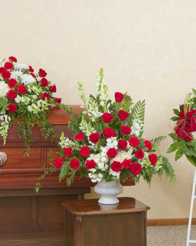 Red and white casket spray, urn and wreath.