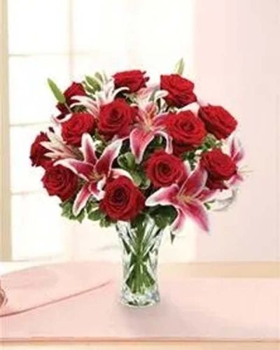 Conjure classic romance with this blossoming bouquet of long-stem red roses, lilies and pittosporum beautifully hand-arranged in an heirloom crystal vase.