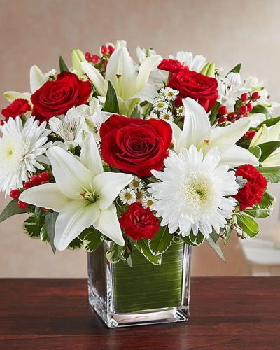 <p>The color most related the heart, let red serve as a reminder that you're thinking of them. Our arrangement of timeless red roses, carnations, and white lilies, expertly gathered together in a clear vase, it is an exquisite gesture of sentiment and caring.</p>